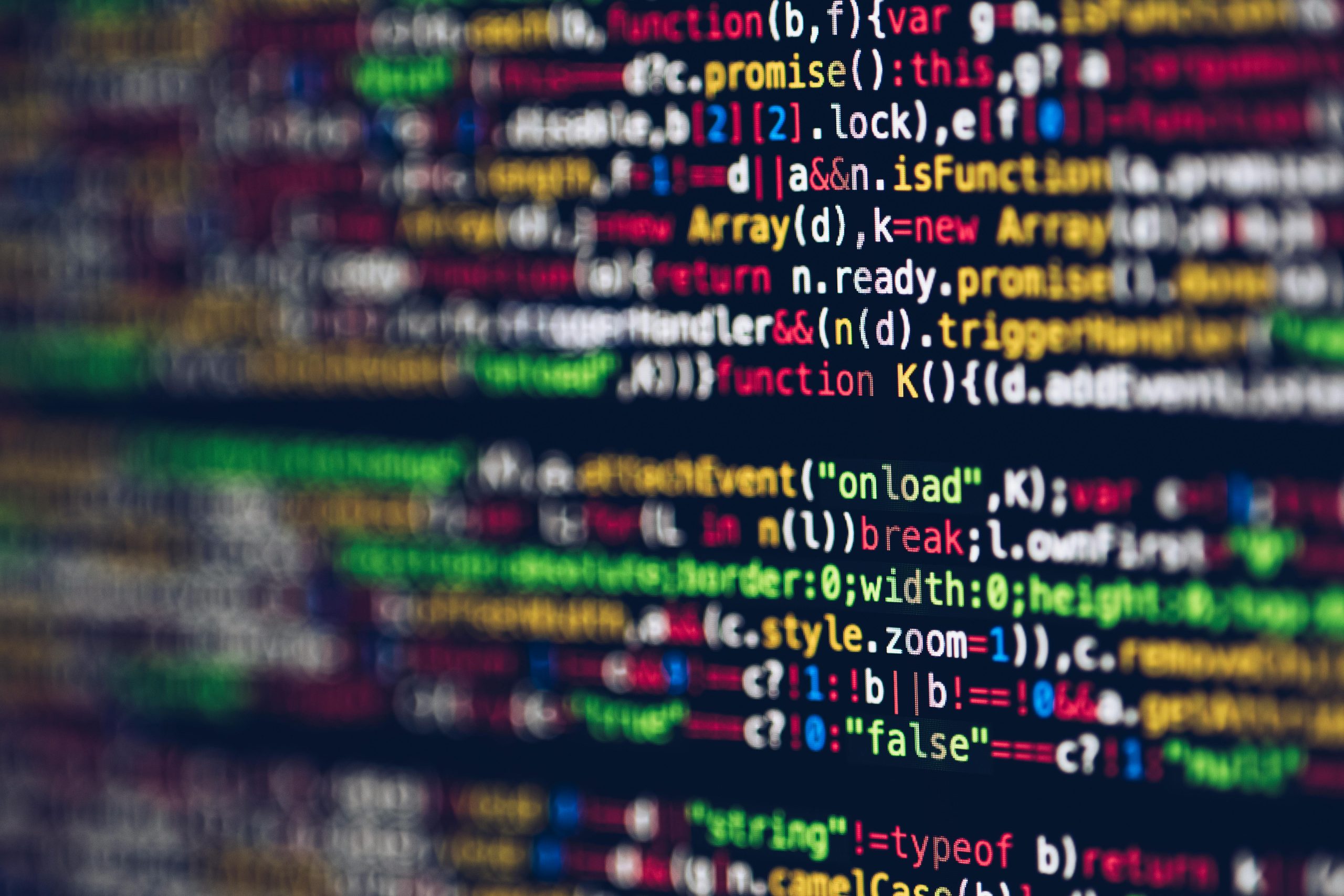 Vivid, blurred close-up of colorful code on a screen, representing web development and programming, business tech solutions.